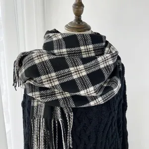 Classic black and white plaid scarf for women and men, warm winter tassel shawl design.