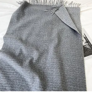 Grey cashmere feel woven fringed scarf detail, elegant texture and soft drape texture.