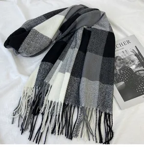 Classic black, white and grey plaid winter scarf with fringed ends for cozy warmth.