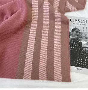 Cozy winter cashmere-feel scarf with chic pink and brown stripes for stylish warmth.