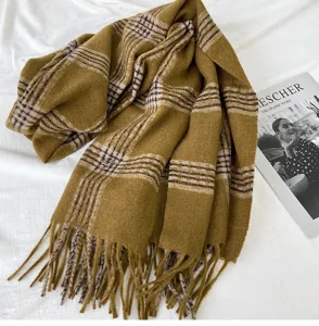 Detailed close-up view of cozy autumn winter warm plaid tassel long scarf shawl.