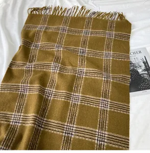 Cozy yellow plaid winter scarf with fringe, warm and soft fashion accessory for women.