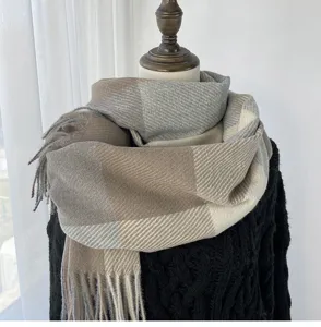 Detailed view of the cozy winter plaid scarf with elegant tassels and soft warm fabric.