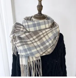 Detailed view of a cozy plaid winter scarf draped gracefully on a mannequin for warmth.