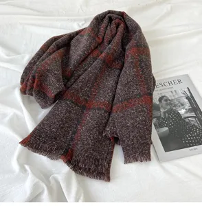 Detailed close-up of a cozy brown plaid fringe scarf, soft winter cashmere-feel accessory.