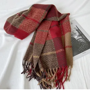 Detail of cozy red brown plaid tassel scarf, soft cashmere-feel fabric, autumn winter style.