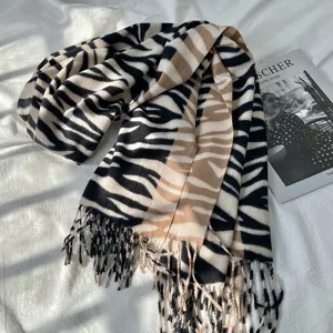 Cozy winter imitation cashmere scarf featuring stylish zebra print and chic fringe details.