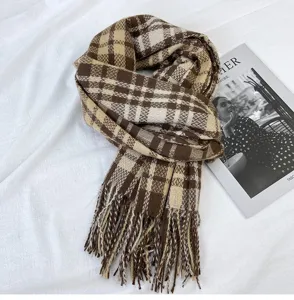 Detail view of the brown and beige plaid winter scarf featuring soft texture and stylish tassel edges.