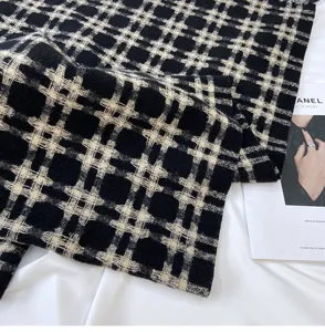 Black and white plaid winter scarf soft cozy warm fashion neckerchief detail texture.