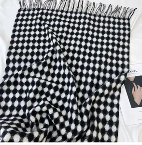 Detailed view of black and white circular grid pattern scarf with elegant fringe tassels.