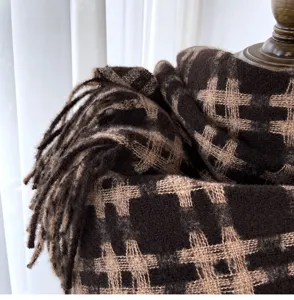 Brown plaid scarf detail shot, cozy cashmere-feel fabric with chic fringe trim for winter.