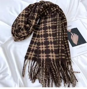 Brown plaid tassel scarf detail view showcasing soft cashmere-feel fabric texture.