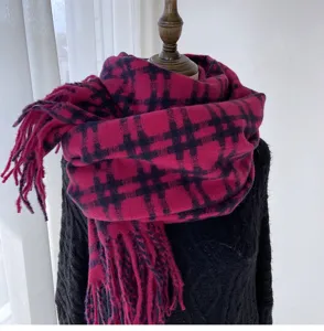 Detailed view of the pink and dark blue plaid winter warm scarf with fringe accents.