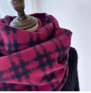 Detailed view of women winter warm plaid scarf, soft cashmere-feel fabric, stylish pattern.