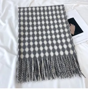 Detailed view of the women winter thick imitation cashmere grid tassel scarf in grey and white.