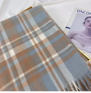 Cozy blue and brown plaid tassel scarf, soft imitation cashmere winter neck warmer accessory.