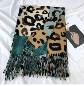 Detailed view of colorblocked leopard print cashmere-feel tassel scarf for winter warmth.
