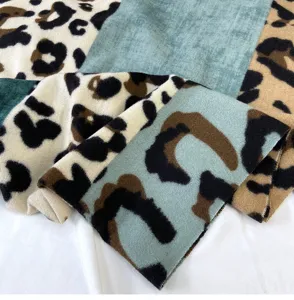 Close-up detail of a soft imitation cashmere color-block leopard print winter scarf.
