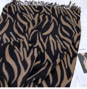Detailed view of the brown and black zebra pattern faux cashmere tassel scarf, autumn winter.