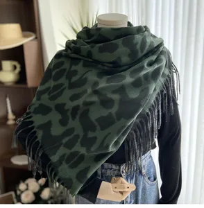 Detailed view of women winter green leopard print scarf with fringe, soft cashmere feel detail.