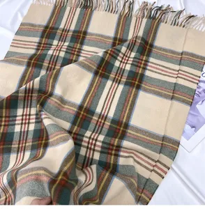 Detailed view of the vintage plaid winter cashmere-feel scarf with delicate tassel ends.