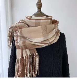 Classic plaid fringe scarf detail shot, warm autumn winter accessory with soft cashmere feel texture.