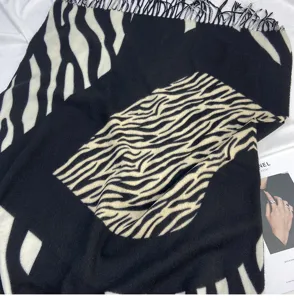 Fashion black and white zebra print imitation cashmere scarf with warm fringe detail.