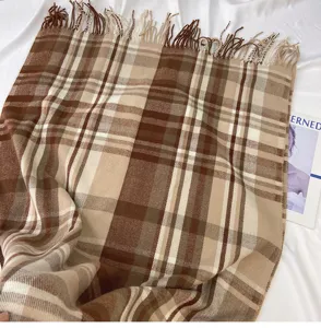 Classic brown plaid fringe imitation cashmere scarf, soft texture detail for winter warmth.