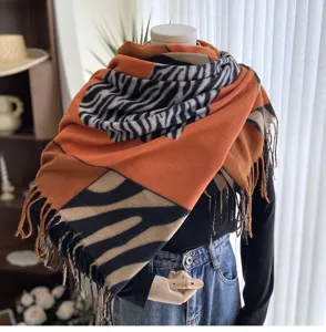 Stylish orange black zebra pattern and tan color block imitation cashmere scarf with fringe.