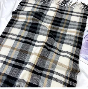 Classic plaid pattern winter scarf detail, soft faux cashmere fabric with fringe trim.