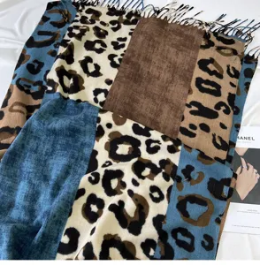 Detailed view showing the soft cashmere-feel texture of the color-block leopard scarf.