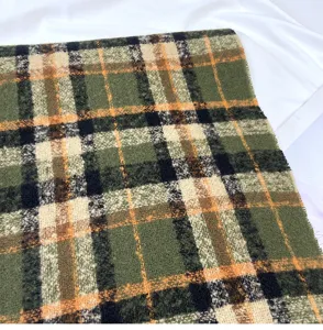 Detailed view of the winter retro green plaid imitation cashmere scarf fabric, soft and cozy texture.