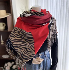 Detailed view of women's warm zebra print cashmere feel scarf with fringe winter shawl.