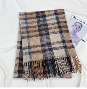 Detailed view of winter classic plaid cashmere-feel scarf with elegant fringe trim.