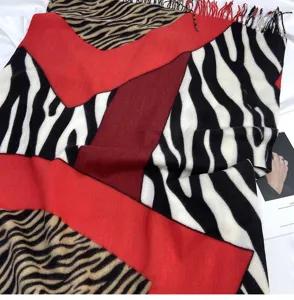 Women imitation cashmere scarf with bold zebra print and red color block fashion design.