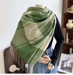 Detail view of the green and beige plaid imitation cashmere scarf with elegant fringe trim.