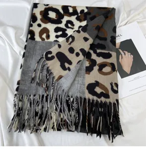 Close-up detail of luxurious color-block leopard print cashmere-feel tassel winter scarf.