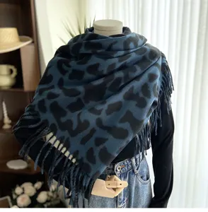 Blue leopard print cashmere feel scarf with fringe, stylish and warm winter fashion accessory.