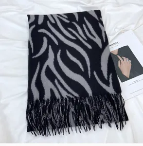 Cozy black and grey zebra print knitted tassel scarf for women, warm winter fashion accessory.
