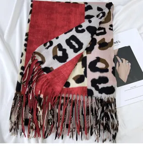 Color-blocked leopard print cashmere-feel scarf detail showing rich tassels and soft texture.