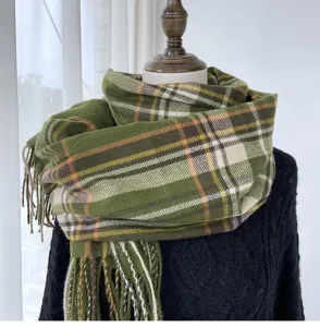 Detailed view of the green plaid scarf with classic fringe and soft cashmere-feel fabric.