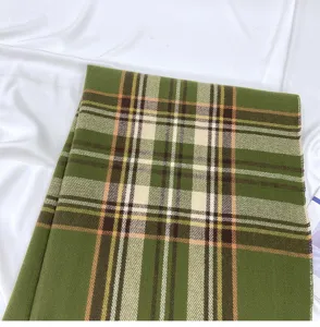 Detailed close-up of the green plaid scarf, showcasing the soft texture and retro pattern.