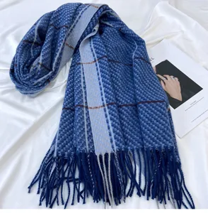 Detailed view of the blue plaid cashmere-feel winter scarf with elegant fringe and soft texture.