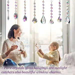 Hanging crystal glass suncatchers detail view, reflecting rainbow light in indoor scene.
