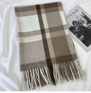 Classic plaid winter scarf with cozy fringe design, warm and stylish accessory for women.