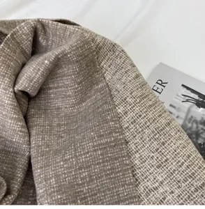 Cozy imitation cashmere winter scarf detail, soft brown knitted shawl texture for women.