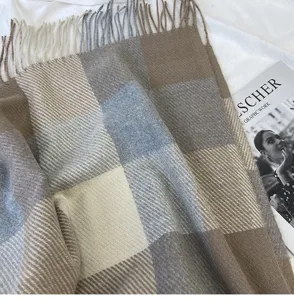 Detailed close-up view of the winter thick plaid tassel scarf texture and cozy fabric.