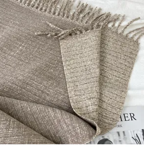 Close up view of cozy camel tassel scarf knit texture winter warm cozy wrap shawl detail.