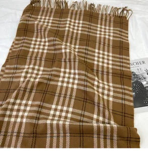 Detailed view of brown plaid scarf with fringe, classic British style winter warm cashmere feel.