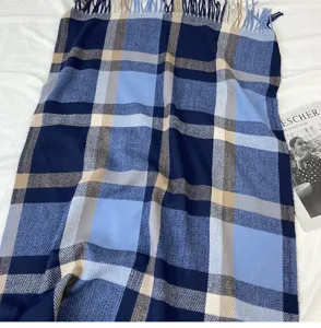 Blue and navy plaid scarf for women, featuring soft cashmere-feel fabric with chic tassels.